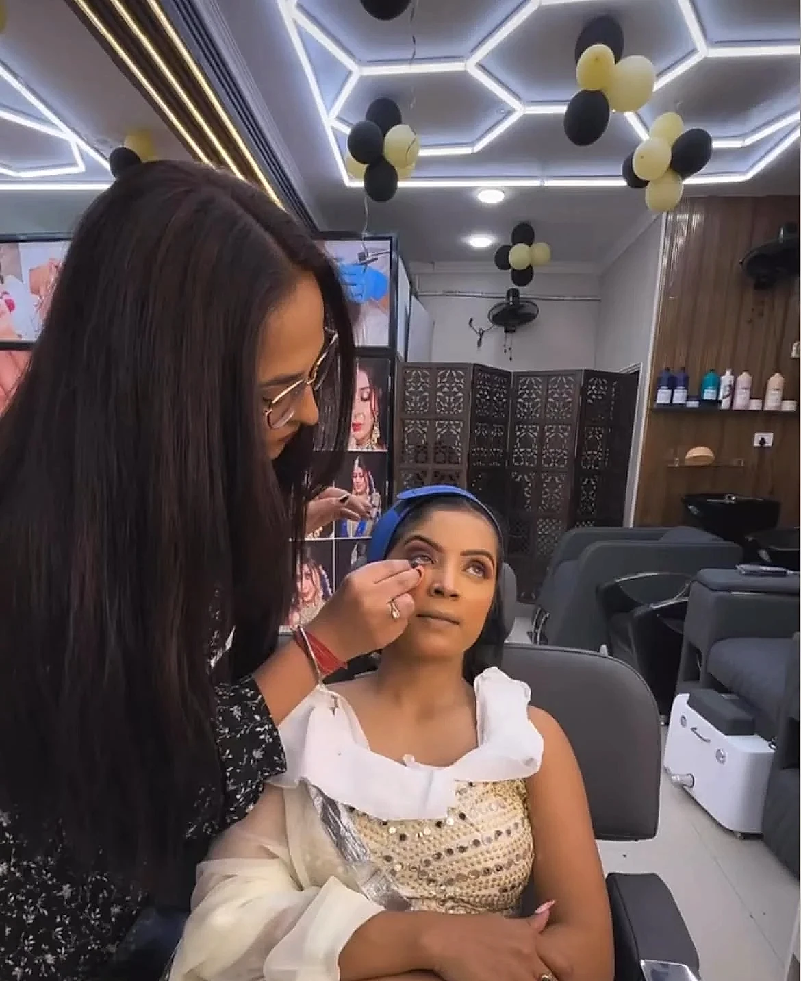 Twinkle Arora Founder & Professional Cosmetologist styling client inside salon studio