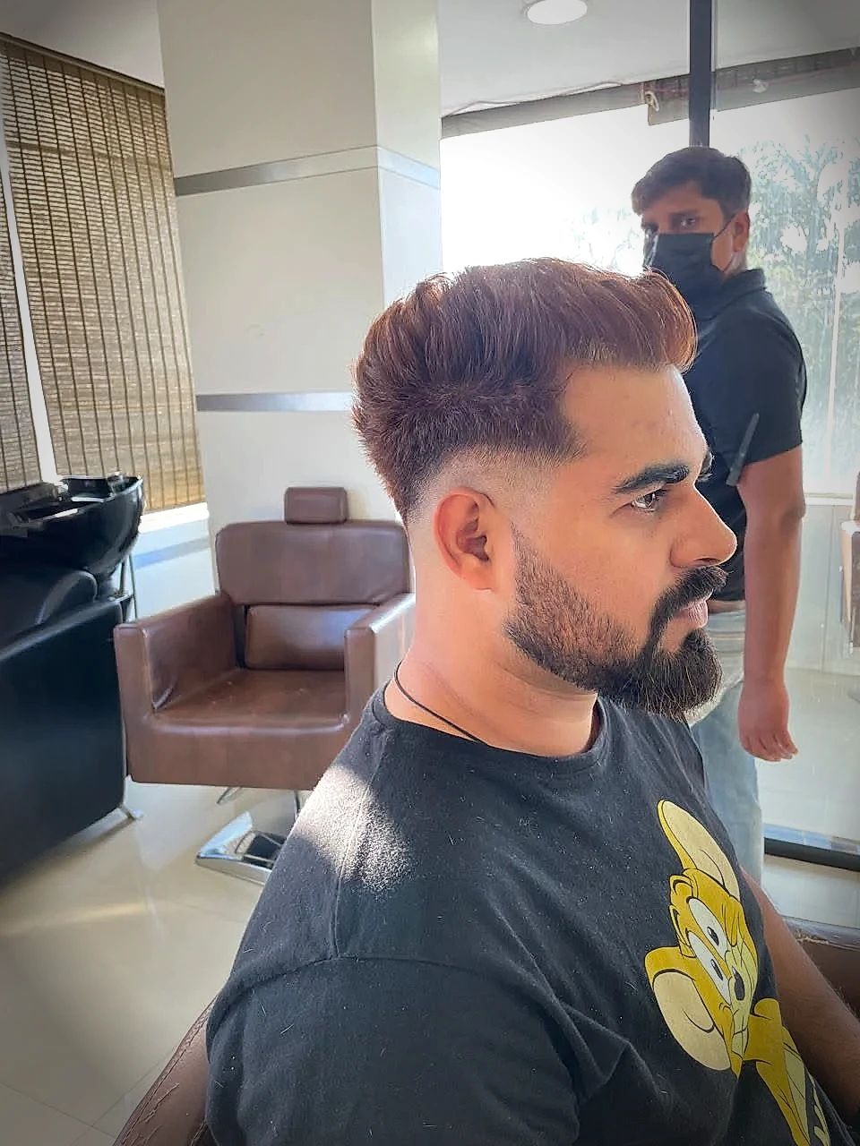 Modern textured quiff and detailed beard grooming by professional male stylist